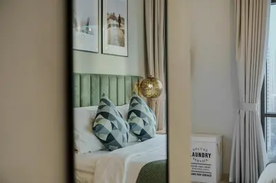 a mirror reflection of a bed in a bedroom at Tranquil & Modern 2BR - Vida Residence Creek Beach in Dubai