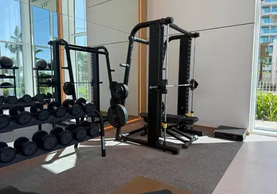 a gym with two treadmills and weights at La Vie Beachside Elegance in Dubai