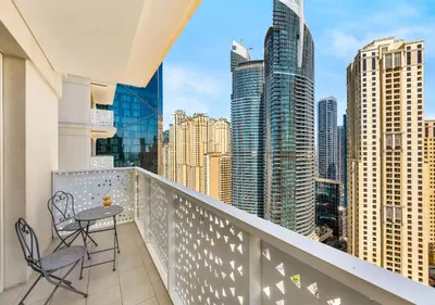 a balcony with two chairs and a table at La Vie Beachside Elegance in Dubai