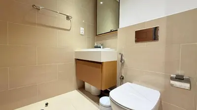 a bathroom with a white toilet and a sink at Premium 2 Bedroom at Creek Horizon in Dubai