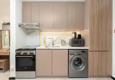a kitchen with a sink and a washing machine at Burj View - Luxury Studio - Near Dubai Miracle & Butterfly Garden- Arjan, Dubailand in Dubai