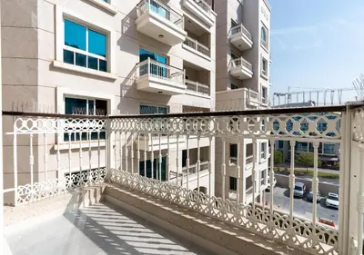 a balcony of a building with a white railing at Burj View - Luxury Studio - Near Dubai Miracle & Butterfly Garden- Arjan, Dubailand in Dubai
