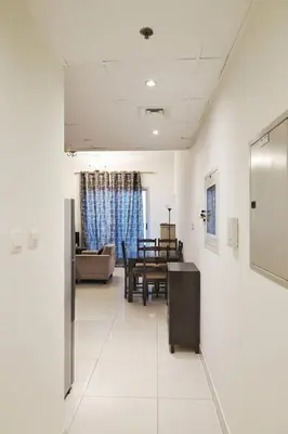 a living room with a table and a dining room at Sport City with gym, pool, sauna in Dubai