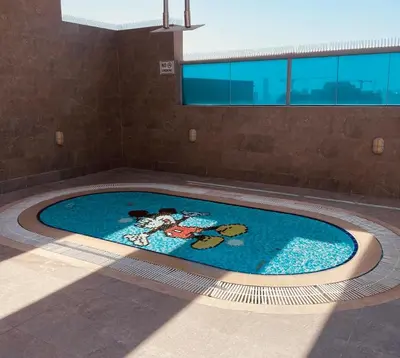 a swimming pool with a painting of animals in it at Sport City with gym, pool, sauna in Dubai