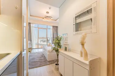 a kitchen and living room with a large window at Studio Near Dubai Creek, Dubai Frame & Downtown, Farhad Azizi, Al Jaddaf by Deluxe Holiday Homes in Dubai