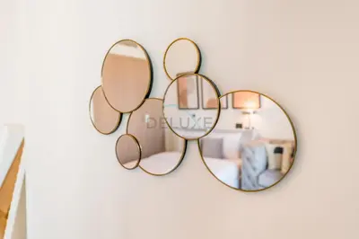a group of mirrors hanging on a wall at Studio Near Dubai Creek, Dubai Frame & Downtown, Farhad Azizi, Al Jaddaf by Deluxe Holiday Homes in Dubai