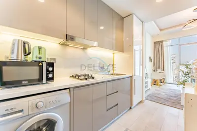 a kitchen with a washer and dryer at Studio Near Dubai Creek, Dubai Frame & Downtown, Farhad Azizi, Al Jaddaf by Deluxe Holiday Homes in Dubai