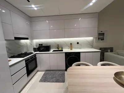 a kitchen with white cabinets and a stove at 1 Bedroom in Binghatti Lavender in Dubai