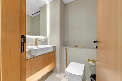 a bathroom with a white toilet and a sink at 1 Bedroom in Binghatti Lavender in Dubai