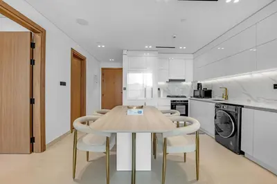 a kitchen with a table and chairs in it at 1 Bedroom in Binghatti Lavender in Dubai