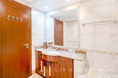 a bathroom with a sink and a mirror at LUX The Al Seef Marina 4 bed Suite in Dubai