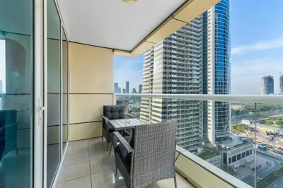 a balcony with chairs and a view of a city at Stylish 1BR in Marina, Balcony Near JBR in Dubai