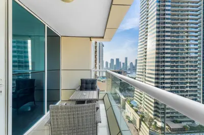 a balcony with chairs and a view of the city at Stylish 1BR in Marina, Balcony Near JBR in Dubai
