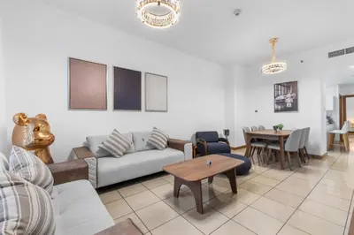 a living room with a couch and a table at Stylish 1BR in Marina, Balcony Near JBR in Dubai