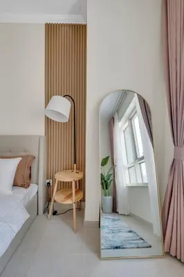 a bedroom with a mirror and a bed and a table at Dubai Marina Promenade 1BR Apartment with Pool near JBR in Dubai
