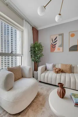 a living room with two white chairs and a couch at Dubai Marina Promenade 1BR Apartment with Pool near JBR in Dubai