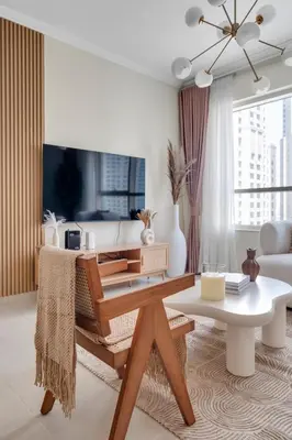 a living room with a table and a couch at Dubai Marina Promenade 1BR Apartment with Pool near JBR in Dubai