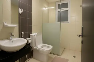 a bathroom with a toilet and a sink and a shower at Single Bed In Twin Room With Balcony For Female Guests Only in Dubai