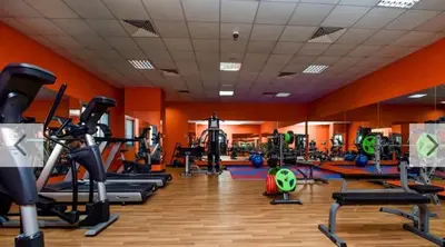 a gym with a bunch of exercise equipment in a room at Single Bed In Twin Room With Balcony For Female Guests Only in Dubai