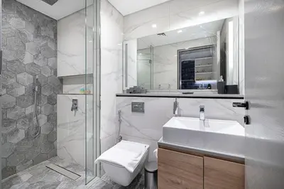 a bathroom with a sink and a toilet and a mirror at Cosy Studio, 7-min walk Burj Khalifa and Dubai Mall in Dubai