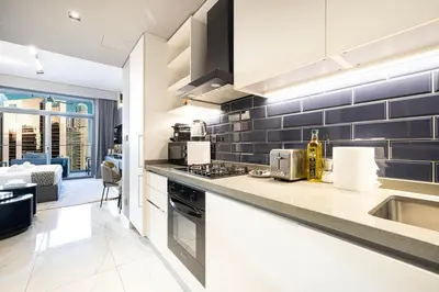 a kitchen with a sink and a counter top at Cosy Studio, 7-min walk Burj Khalifa and Dubai Mall in Dubai