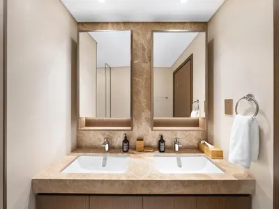 a bathroom with two sinks and two mirrors at Luxury Spacious 2 Bedroom Private Beach and Views in Dubai