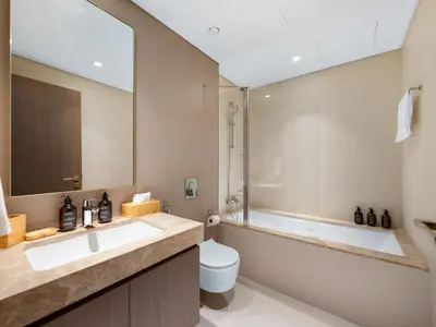 a bathroom with a sink and a toilet and a tub at Luxury Spacious 2 Bedroom Private Beach and Views in Dubai