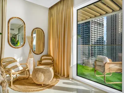 a living room with a large window with a view of a city at Luxury Spacious 2 Bedroom Private Beach and Views in Dubai