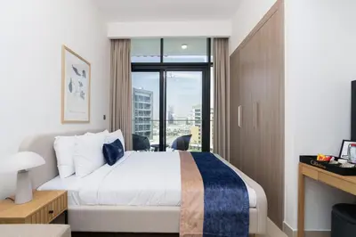 a hotel room with a bed and a large window at CitiHome - Studio Azizi Riviera in Dubai
