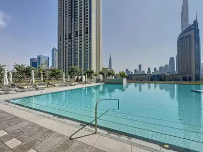 a large swimming pool in the middle of a city at Downtown Views 3 - Chic One Bed with City Views in Dubai