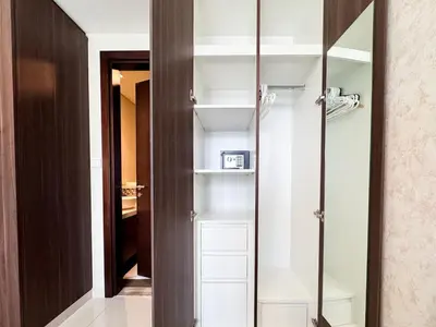 a closet with white shelves and a glass door at Bronzite 2-Bed Apt Central Dubai Canal Views in Dubai