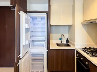 an empty refrigerator with its door open in a kitchen at Bronzite 2-Bed Apt Central Dubai Canal Views in Dubai
