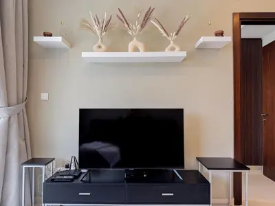a living room with a black entertainment center with a flat screen tv at Bronzite 2-Bed Apt Central Dubai Canal Views in Dubai