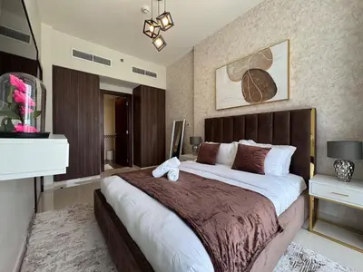 a bedroom with a large bed in a room at Bronzite 2-Bed Apt Central Dubai Canal Views in Dubai