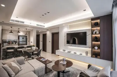 a living room with a couch and a tv and a table at QUARTZ Luxe 1-Bed at Nobles Tower, Near Downtown in Dubai