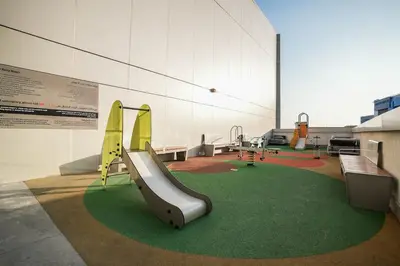 a play room with a slide and swings at QUARTZ Luxe 1-Bed at Nobles Tower, Near Downtown in Dubai