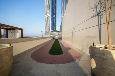 a view of a building with a green floor in the middle at QUARTZ Luxe 1-Bed at Nobles Tower, Near Downtown in Dubai