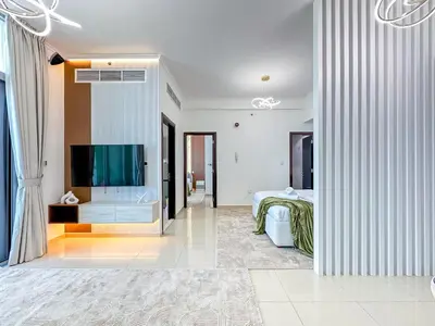 a hotel room with a bed and a flat screen tv at Upgrade Unit for 6 pax with Sea View Ideal Location Near Beach Big Balcony in Dubai