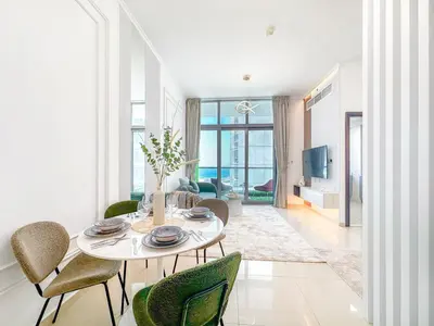 a dining room with a table and chairs at Upgrade Unit for 6 pax with Sea View Ideal Location Near Beach Big Balcony in Dubai