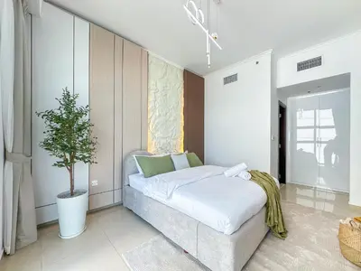 a bedroom with a bed and a potted tree at Upgrade Unit for 6 pax with Sea View Ideal Location Near Beach Big Balcony in Dubai
