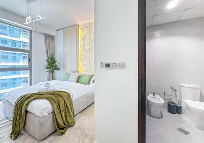 a bedroom with a bed and a bathroom with a shower at Upgrade Unit for 6 pax with Sea View Ideal Location Near Beach Big Balcony in Dubai
