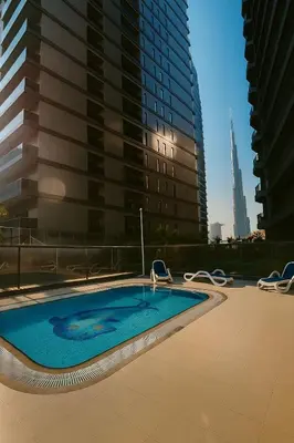 a swimming pool in the middle of a city with buildings at Premium 3BR Downtown Retreat with Pool & Iconic Burj Views in Dubai