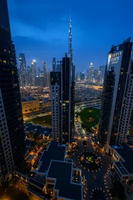 a city skyline at night with tall buildings at Premium 3BR Downtown Retreat with Pool & Iconic Burj Views in Dubai