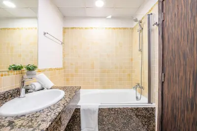 a bathroom with a sink and a bath tub at Luxury JBR 2BR Shams Full Marina View Free 5 Star Beach Resorts Access in Dubai