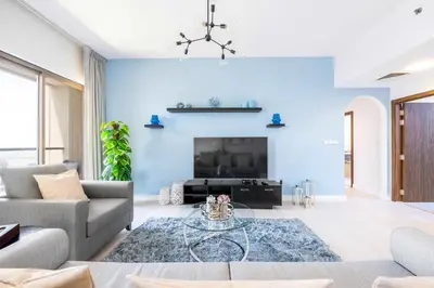 a living room with a blue wall at Luxury JBR 2BR Shams Full Marina View Free 5 Star Beach Resorts Access in Dubai