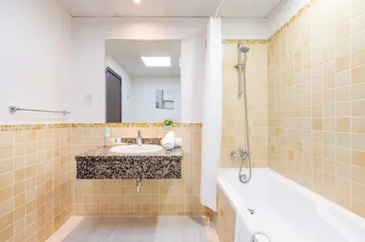 a bathroom with a sink and a tub at Luxury JBR 2BR Shams Full Marina View Free 5 Star Beach Resorts Access in Dubai