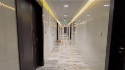 a hallway in a building with a long corridor at Luxurious apartment 8 mins from Burj Khalifa in Dubai