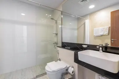 a bathroom with a sink and a toilet and a mirror at Luxurious apartment 8 mins from Burj Khalifa in Dubai