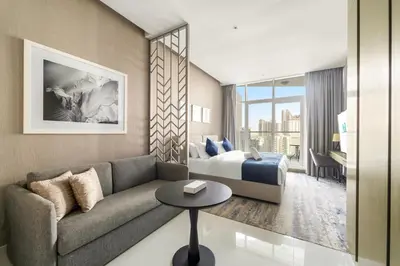 a living room with a couch and a bed at ALiving Luxury Studio with Balcony Views Prive 2007B in Dubai