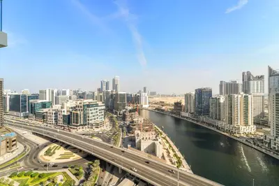 a city with a bridge over a river and buildings at ALiving Luxury Studio with Balcony Views Prive 2007B in Dubai